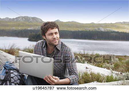 Stock Photo - Tourist with a laptop. Fotosearch
