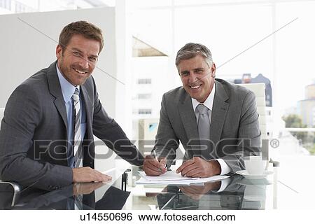 Two businessmen negotiating View Large Photo Image Stock Photograph - Two businessmen negotiating. Fotosearch
