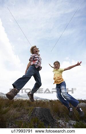 Two kids jumping View Large Photo Image Stock Image - Two kids jumping. Fotosearch