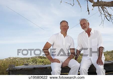 Stock Image - Two men in countryside. Fotosearch