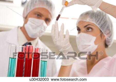Two scientists at work View Large Photo Image Stock Image - Two scientists at work. Fotosearch