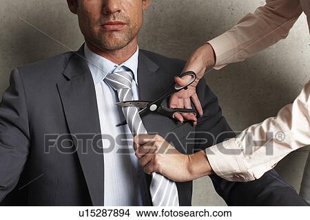 Picture - Woman cutting man's tie. Fotosearch