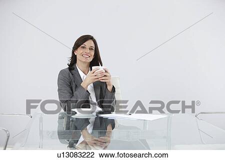 Stock Image - Woman in her office. Fotosearch
