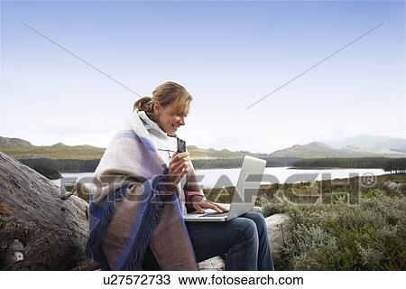 Stock Image - Woman paying for online purchases. Fotosearch
