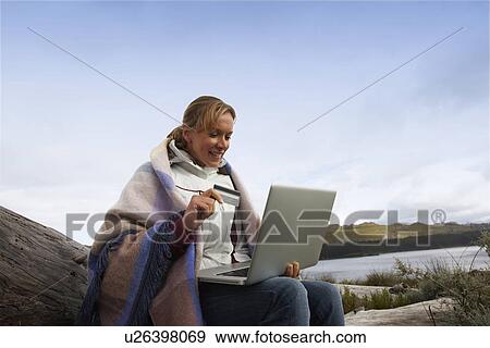 Stock Photo - Woman paying online. Fotosearch