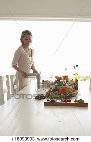 Stock Image - Woman preparing a meal. Fotosearch