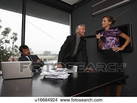 Picture - Woman pulling businesman tie. Fotosearch
