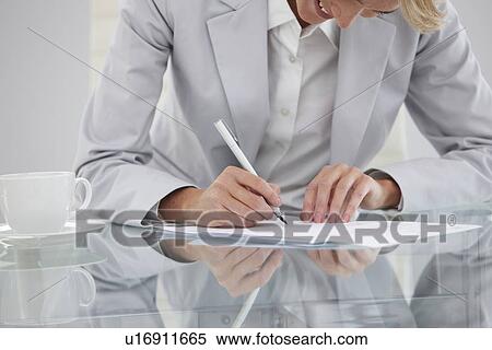 Woman signing a contract View Large Photo Image Stock Photography - Woman signing a contract. Fotosearch