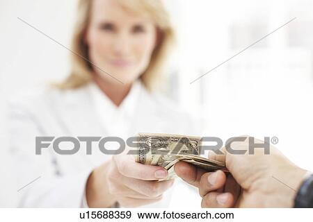 Stock Photo - Woman taking money. Fotosearch