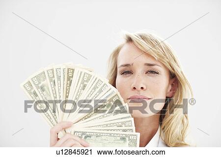 Stock Image - Woman with a money fan. Fotosearch
