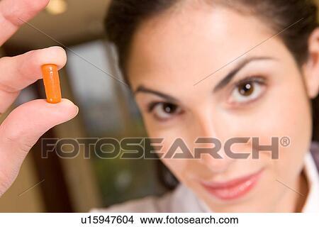 Picture - Woman with a pill portrait. Fotosearch