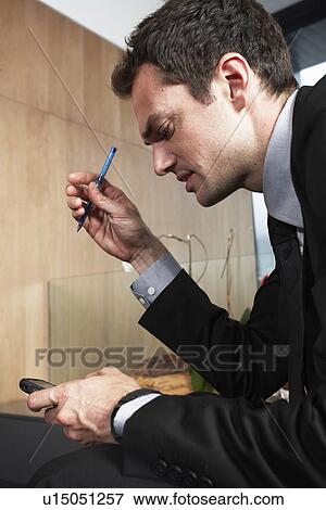 Stock Photo - Young businessman at work. Fotosearch