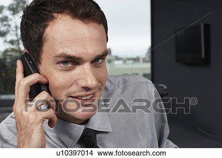 Young businessman on a phone View Large Photo Image Picture - Young businessman on a phone. Fotosearch