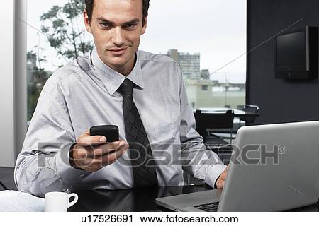 Young businessman with a computer View Large Photo Image Stock Image - Young businessman with a computer. Fotosearch