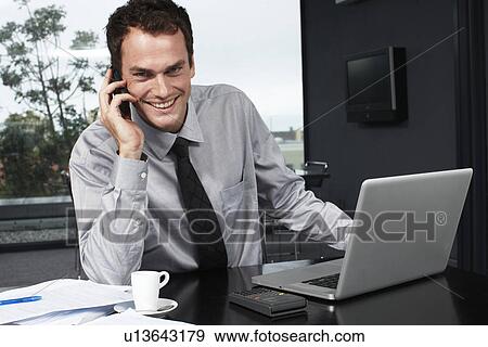 Young businessman with a phone View Large Photo Image Stock Photo - Young businessman with a phone. Fotosearch