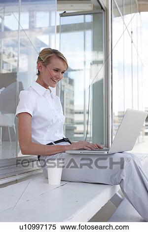 Young businesswoman with a computer View Large Photo Image Stock Photography - Young businesswoman with a computer. Fotosearch