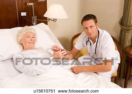 Stock Image - Young doctor and a patient. Fotosearch