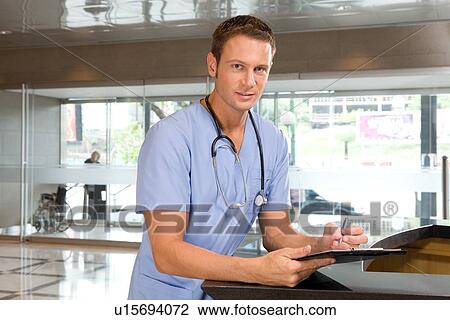 Stock Image - Young doctor at work. Fotosearch