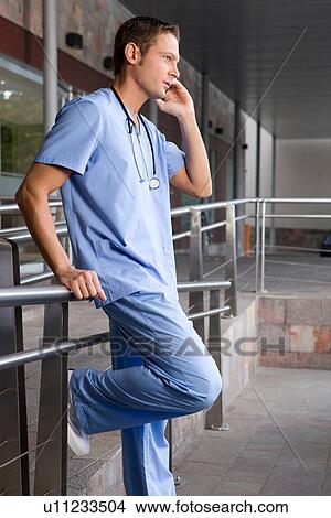 Picture - Young doctor making a call. Fotosearch