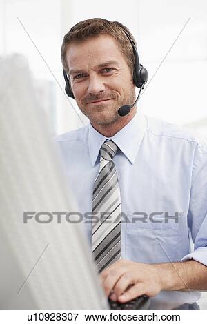 Young employee at work View Large Photo Image Stock Photo - Young employee at work. Fotosearch
