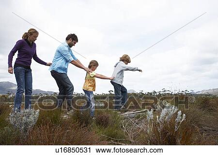 Stock Image - Young family in the countryside. Fotosearch