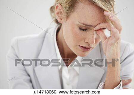 Stock Image - Young girl having a headache. Fotosearch