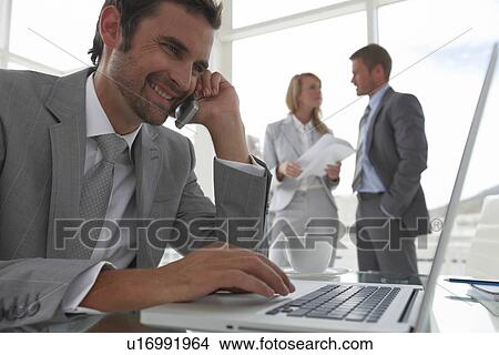 Picture - Young man at work. Fotosearch