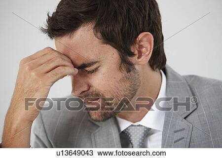 Young man having a headache View Large Photo Image Stock Image - Young man having a headache. Fotosearch