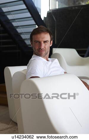 Stock Image - Young man in a luxurious house. Fotosearch