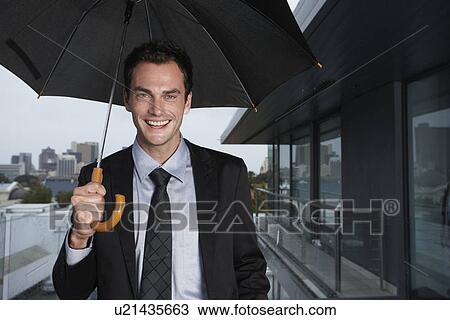 Stock Image - Young man in the rain. Fotosearch