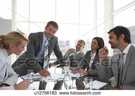 Young man leading a meeting View Large Photo Image Stock Image - Young man leading a meeting. Fotosearch