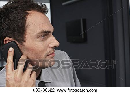 Young man on a phone View Large Photo Image Stock Image - Young man on a phone. Fotosearch