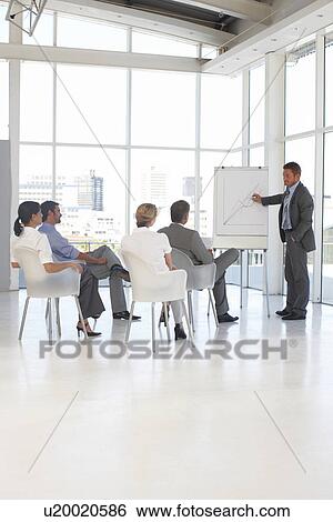 Young man presenting View Large Photo Image Stock Photograph - Young man presenting. Fotosearch