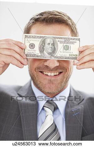 Young man with a dollar note View Large Photo Image Stock Image - Young man with a dollar note. Fotosearch