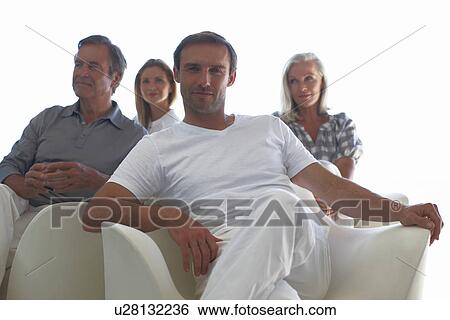 Young man with people in the background View Large Photo Image Stock Photograph - Young man with people in the background. Fotosearch
