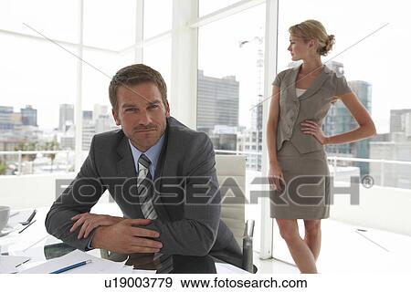Stock Photo - Young man with woman in the background. Fotosearch