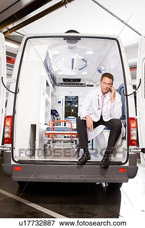 Young paramedic on a phone call View Large Photo Image Stock Photo - Young paramedic on a phone call. Fotosearch