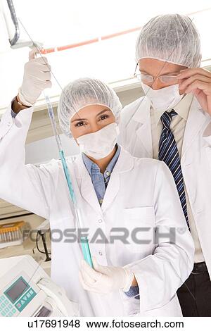 Stock Photo - Young scientists at work. Fotosearch