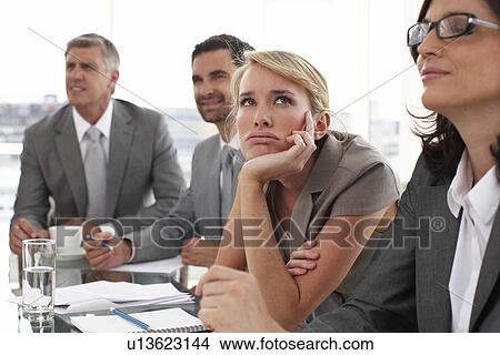 Young woman bored at a meeting View Large Photo Image Picture - Young woman bored at a meeting. Fotosearch