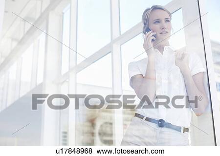 Young woman making a call View Large Photo Image Stock Photo - Young woman making a call. Fotosearch