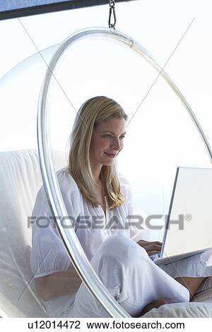 Stock Image - Young woman with a laptop. Fotosearch
