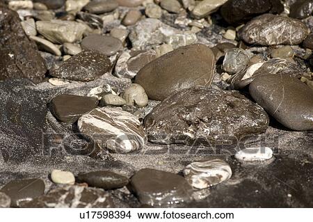 Picture - abstract grey rock formations formed by water erosion. Fotosearch