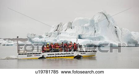 Stock Photography - Amphibious tourist vehicle driving past iceberg. Fotosearch