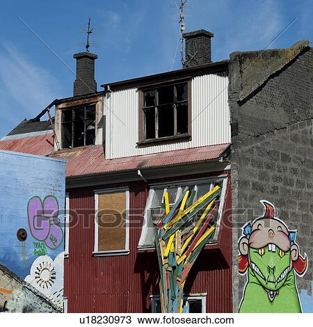 Stock Image - Art covered dwelling with grafitti and sculpture. Fotosearch