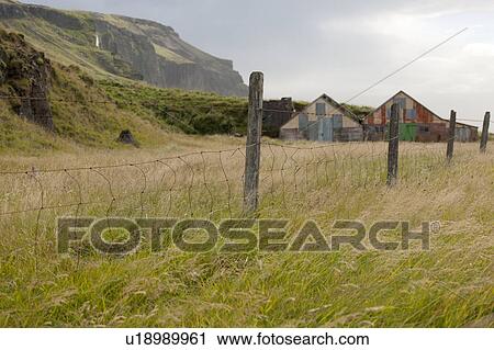 Barbwire fence and fenceposts in a pasture with barns and mountains View Large Photo Image Stock Image - Barbwire fence and fenceposts in a pasture with barns and mountains. Fotosearch
