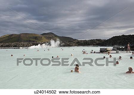 Stock Image - Bathers heads above steaming geothermal mineral waters . Fotosearch