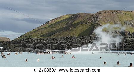 Bathers in geothermal bathing pools, steam rising from the water, mountains in the back View Large Photo Image Stock Photo - Bathers in geothermal bathing pools, steam rising from the water, mountains in the back. Fotosearch