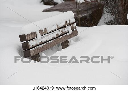 Stock Photo - Bench covered in snow in Vail, Colorado. Fotosearch