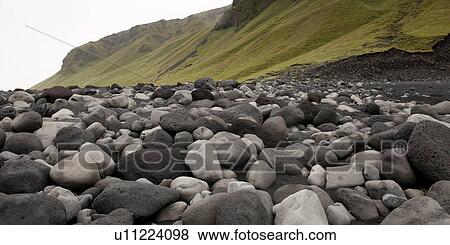 Black and white rocks on the beach, next to grassy slope View Large Photo Image Stock Photo - Black and white rocks on the beach, next to grassy slope. Fotosearch