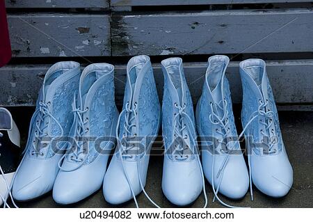 Stock Image - Blue laced boots in a row. Fotosearch